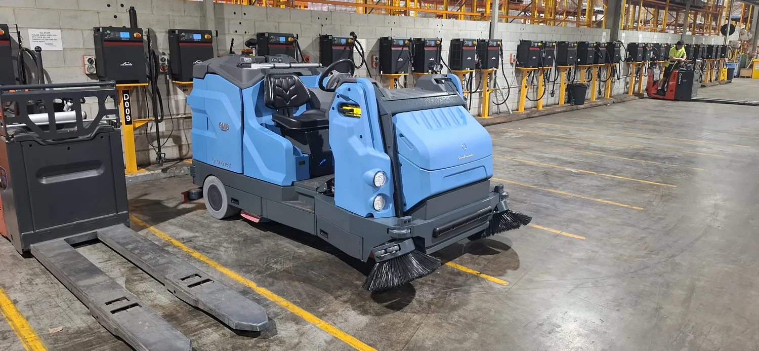 Conquest HDC170 combination sweeper scrubber positioned on a warehouse floor for industrial cleaning
