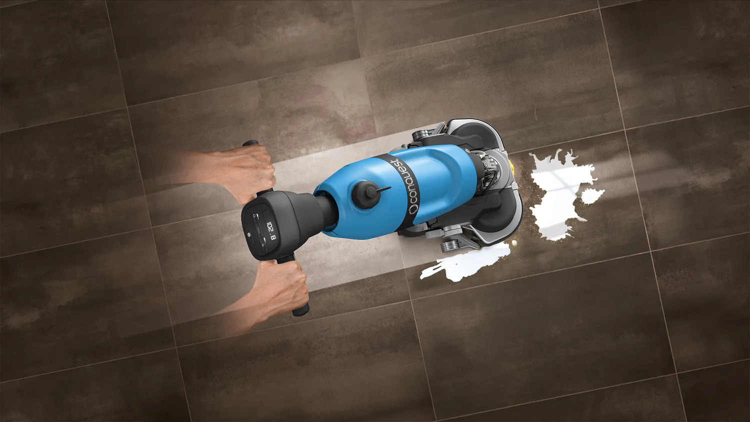 Top-down view of the Conquest HDS46 walk-behind floor scrubber cleaning liquid spills on hard flooring