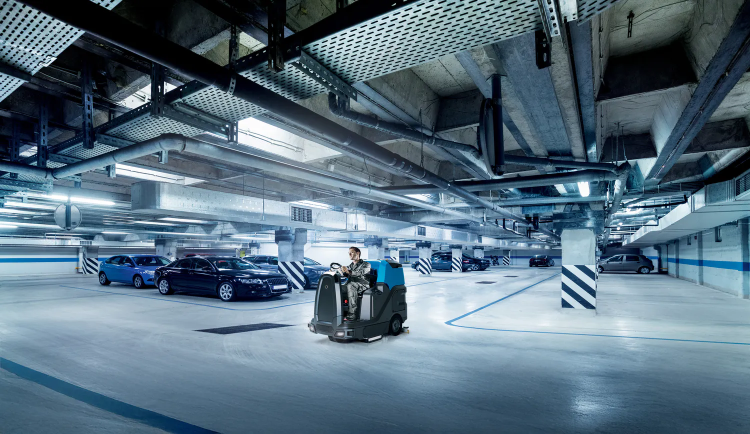 Conquest HDS90 Ride-On Industrial Scrubber cleaning an underground car park for efficient commercial floor maintenance
