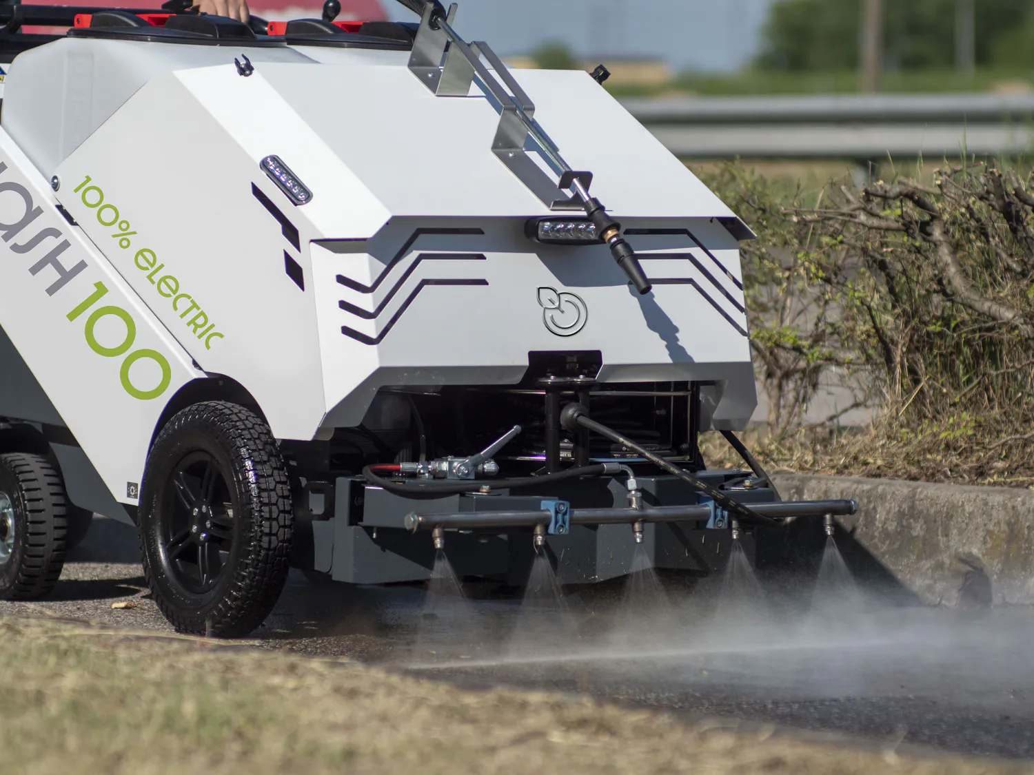 Conquest Front spray bar on the HDSW100 street washer delivering high-pressure water for effective pavement cleaning
