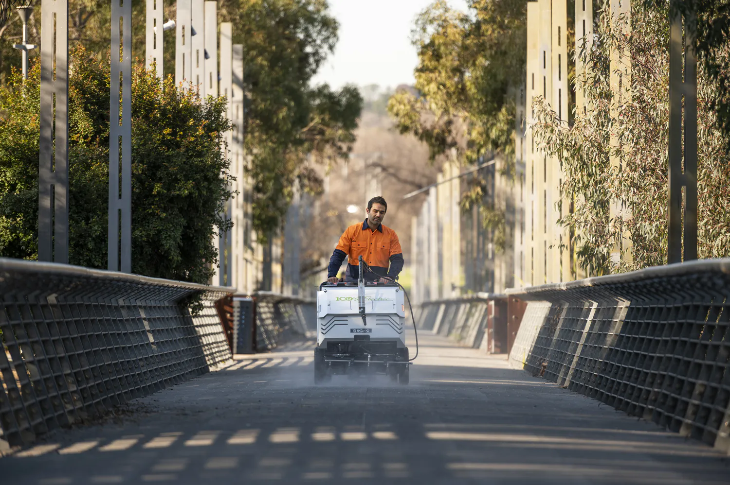 Conquest HDSW100 electric street washer cleaning a pedestrian bridge for efficient public infrastructure maintenance