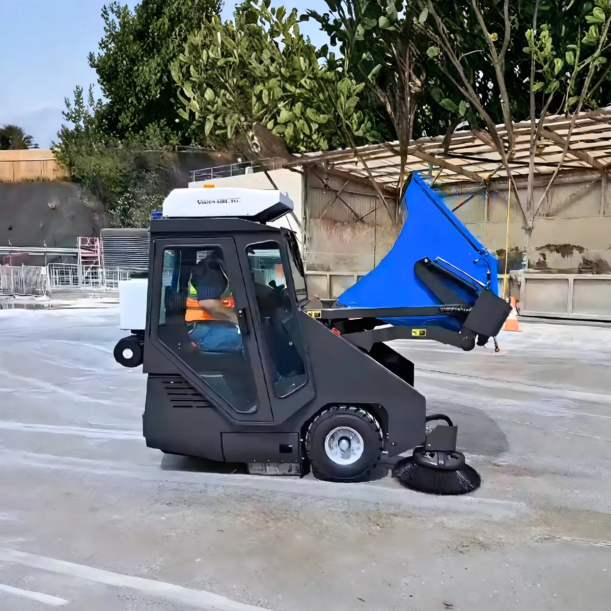 Conquest SD180-HEPA ride-on sweeper demonstrating tilt waste relocation system for fast debris hopper emptying