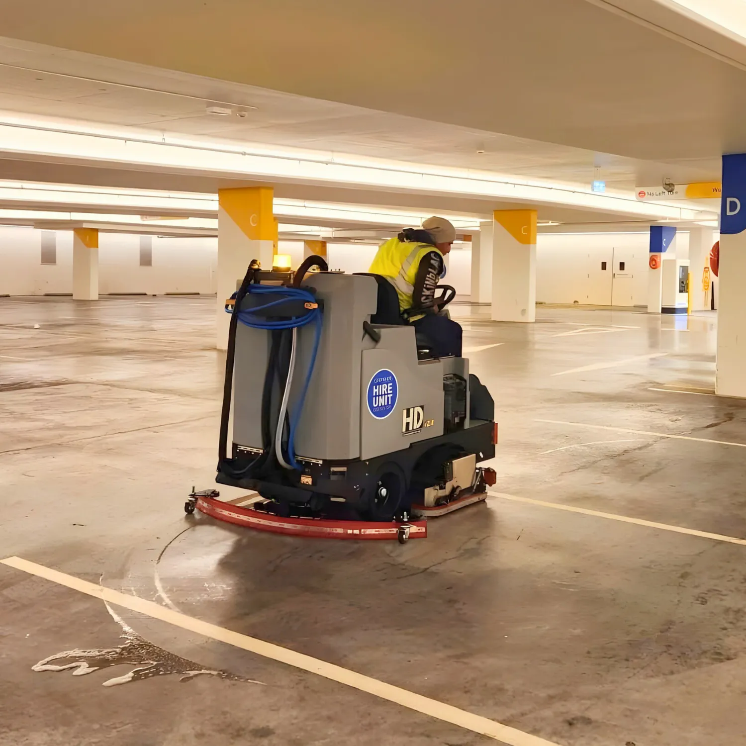 Conquest SDS115 ride-on scrubber cleaning concrete floors in an underground commercial car park