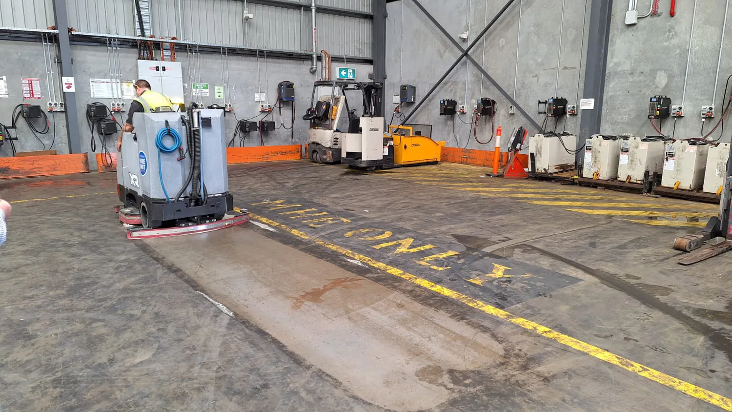 Conquest SDS115 ride on scrubber cleaning food processing facility floors for safe and hygienic industrial cleaning