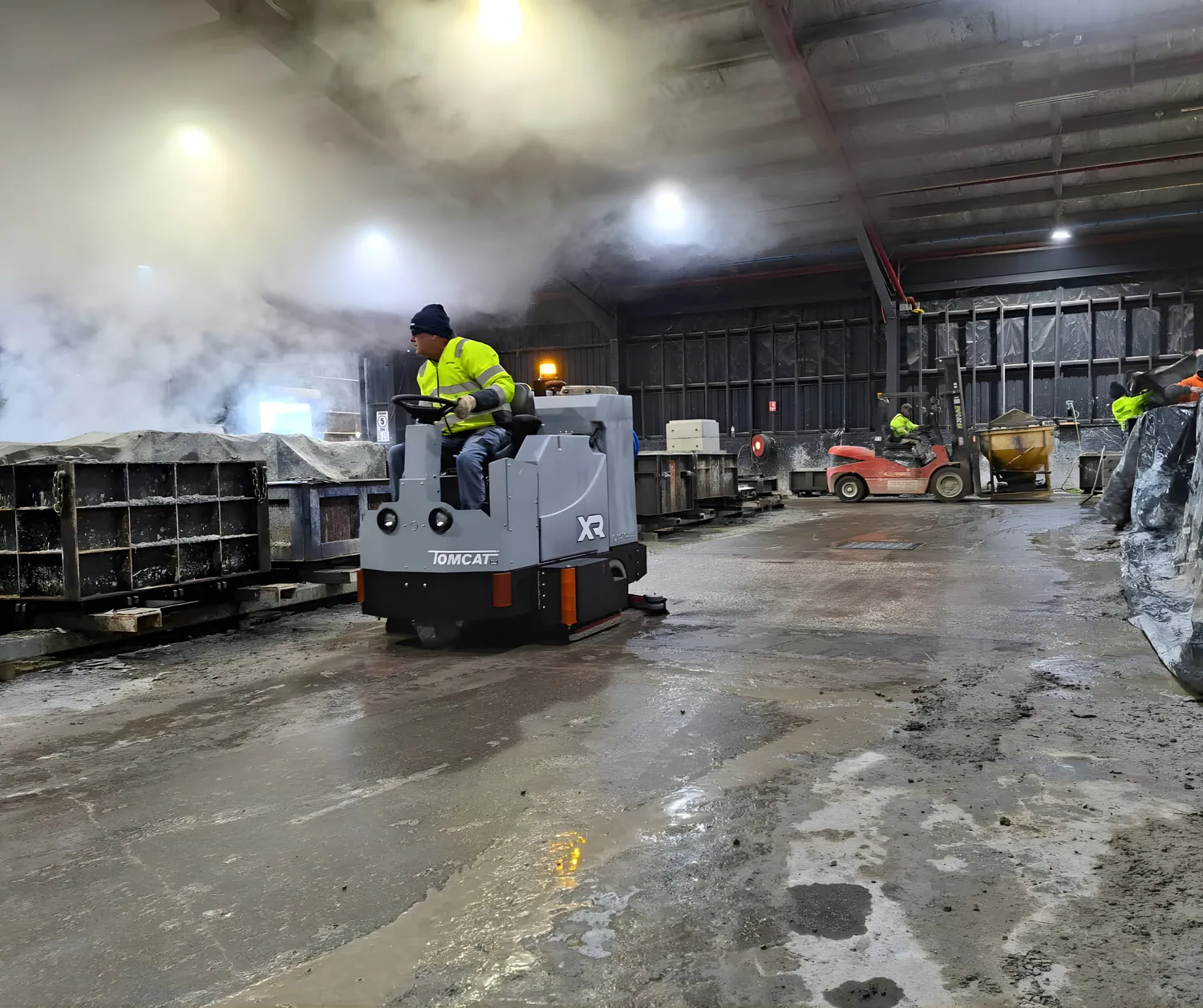 Conquest SDS115 ride on scrubber cleaning industrial facility floors with powerful scrubbing and water recovery performance