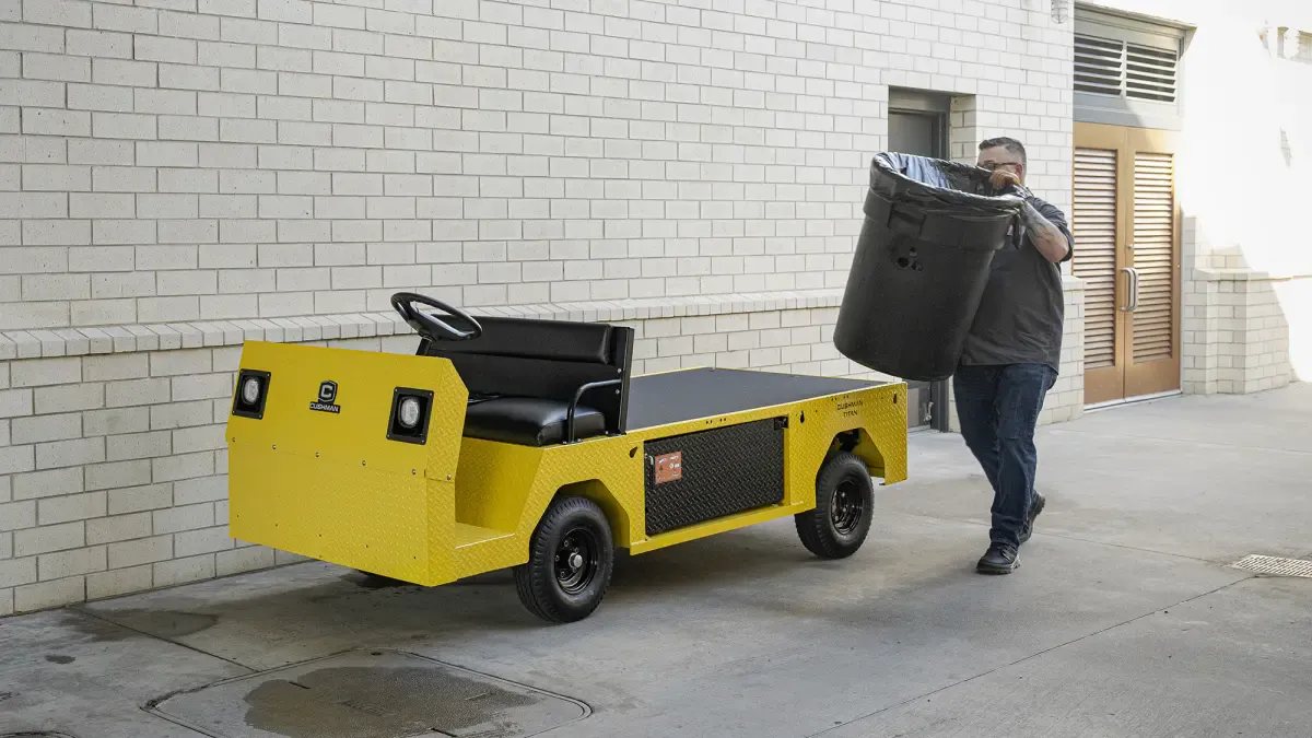 Conquest Titan XD-2 industrial vehicle assisting facility maintenance by transporting waste in a commercial site