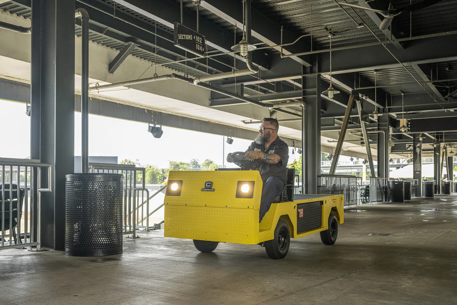 Conquest Titan XD-2 industrial vehicle operating through a stadium concourse for maintenance and transport tasks